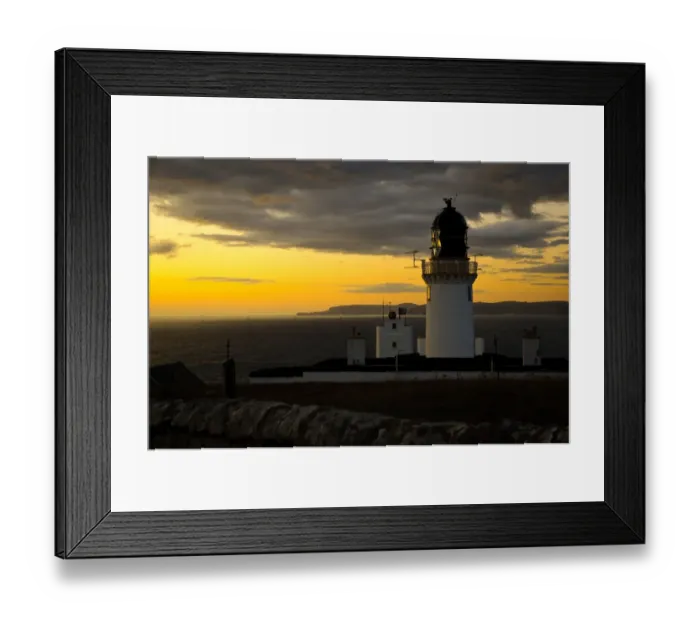 Framed Print : View of clifftop lighthouse at sunset, most northerly point on mainland, with island of Hoy in background Framed Print : View of clifftop lighthouse at sunset, most northerly point on mainland, with island of Hoy in background