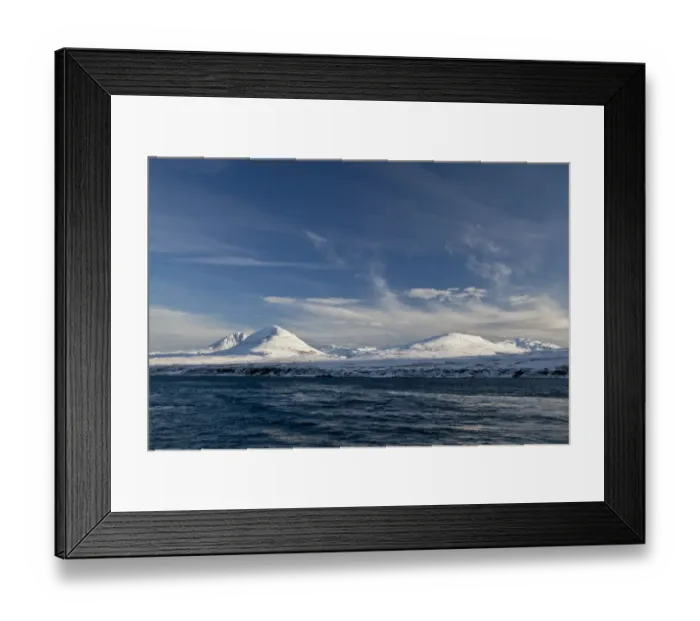 Framed Print : View of coastline with snow covered mountain peaks in background, Paps of Jura, viewed from Sound of Jura