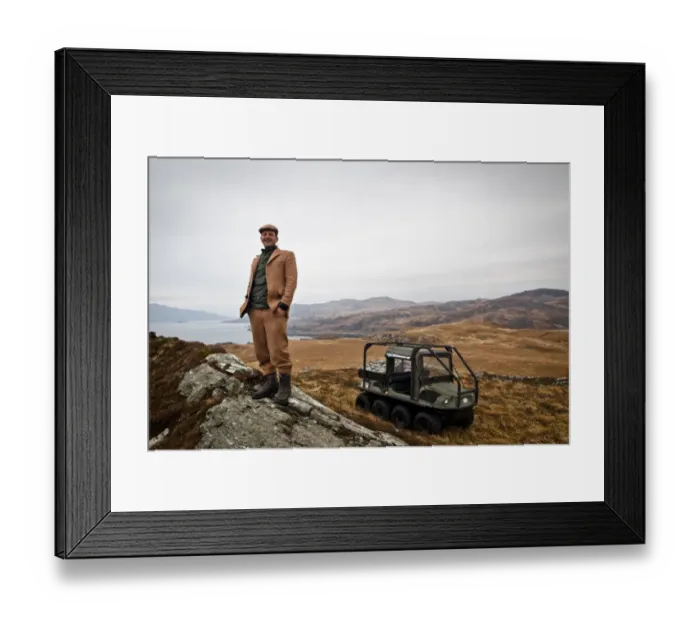 Framed Print : Andrew Fletcher, owner of Adrlussa Estate, standing near Argo 8x8 amphibious all-terrain vehicle on moorland Framed Print : Andrew Fletcher, owner of Adrlussa Estate, standing near Argo 8x8 amphibious all-terrain vehicle on moorland