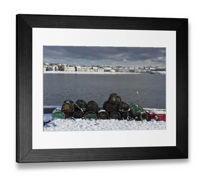 Framed Print : Lobster creels and snow covered seaside town, Port Ellen, Loch Leodamais, Isle of Islay, Inner Hebrides, Scotland