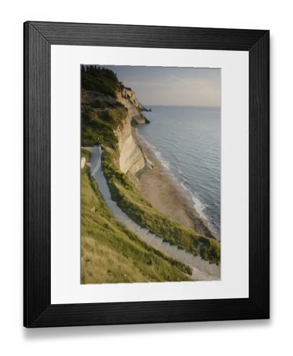 Framed Print : View of steps down to beach from steep cliffs in evening sunlight, Logas Beach, Peroulades, Corfu, Ionian Islands