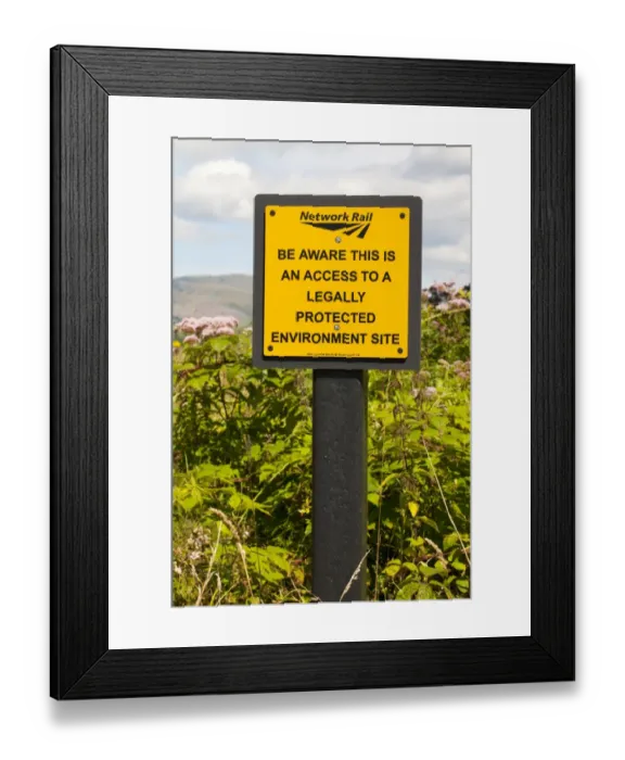 Framed Print : Be Aware This Is An Access To A Legally Protected Environment Site sign warning railworkers that track crosses through Framed Print : Be Aware This Is An Access To A Legally Protected Environment Site sign warning railworkers that track crosses through
