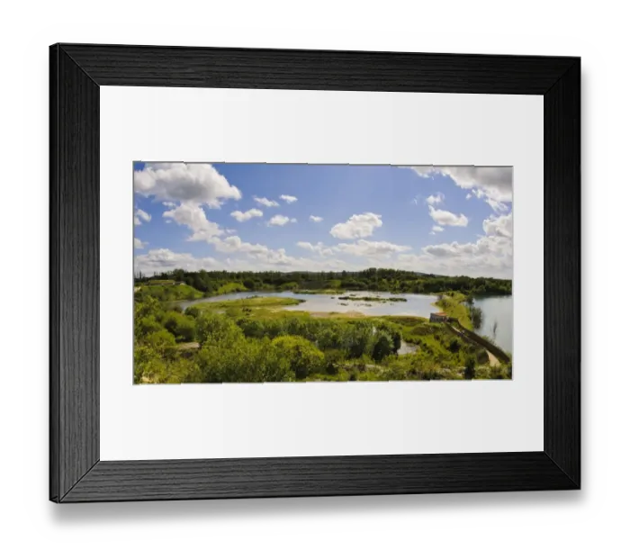 Framed Print : View of wetland habitat in flooded former chalk quarry, with birdwatching hide and visitor centre Framed Print : View of wetland habitat in flooded former chalk quarry, with birdwatching hide and visitor centre