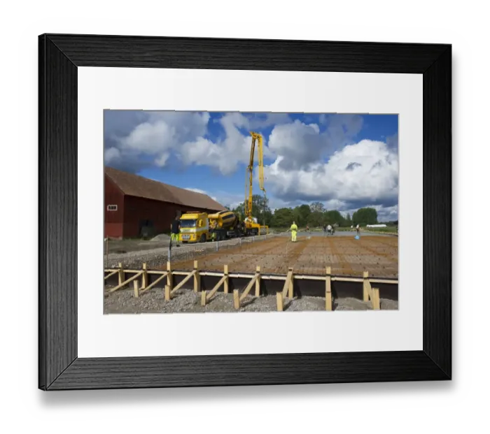Framed Print : Construction work on farm building for loose housing, concrete mixer trunk with concrete poured onto reinforcing bars Framed Print : Construction work on farm building for loose housing, concrete mixer trunk with concrete poured onto reinforcing bars