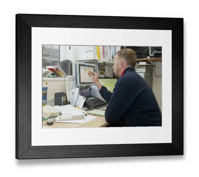 Framed Print : Dairy farming, farmer looking at computer in farm office, England, November Framed Print : Dairy farming, farmer looking at computer in farm office, England, November