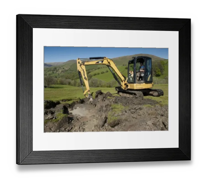 Framed Print : Farmer repairing old blocked drain in upland meadow using mini digger, Cumbria, England, May Framed Print : Farmer repairing old blocked drain in upland meadow using mini digger, Cumbria, England, May