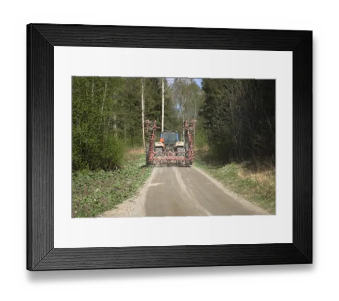 Framed Print : Tractor with harrow, driving along road in woodland, Sweden Framed Print : Tractor with harrow, driving along road in woodland, Sweden