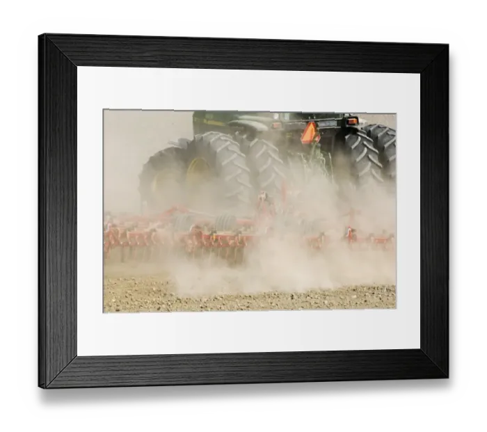 Framed Print : Close-up of tractor pulling harrows, harrowing field with wind blown dust, Sweden, spring Framed Print : Close-up of tractor pulling harrows, harrowing field with wind blown dust, Sweden, spring