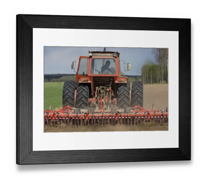 Framed Print : Volvo tractor pulling harrows, cultivating arable field, Sweden