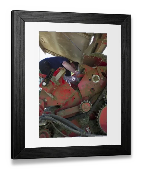 Framed Print : Farmer working on round baler, Sweden, june Framed Print : Farmer working on round baler, Sweden, june
