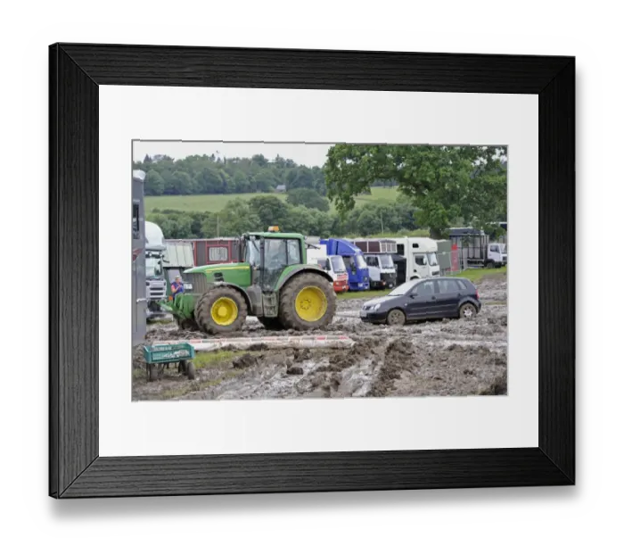Framed Print : John Deere 6930 tractor pulling car out of muddy carpark at agricultural show, which was cancelled due to bad weather