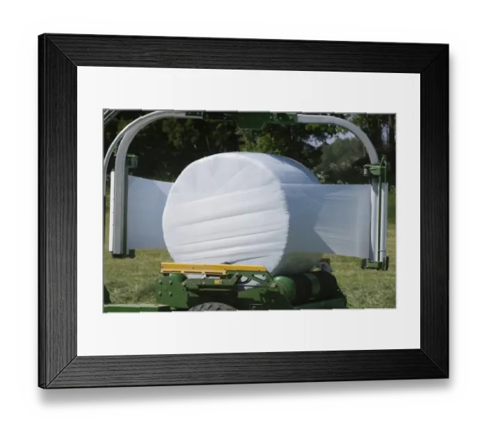 Framed Print : Plastic wrapping round silage bale with mechanical bale-wrapper, Sweden Framed Print : Plastic wrapping round silage bale with mechanical bale-wrapper, Sweden