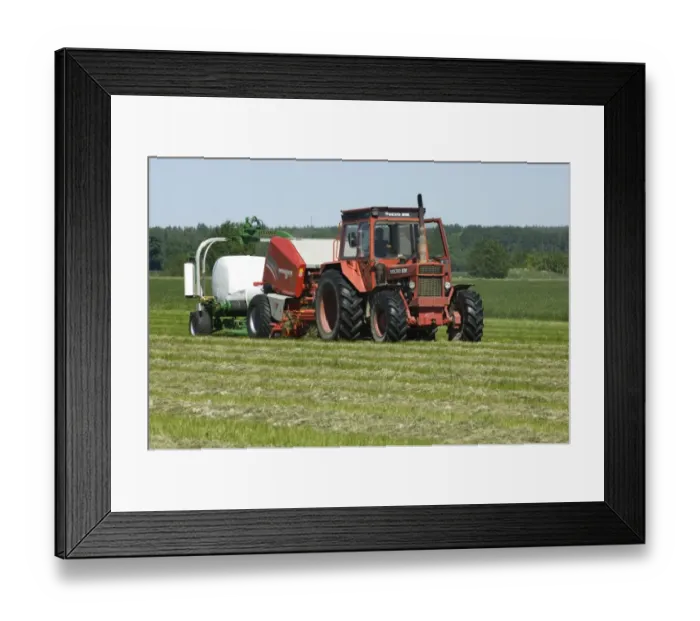 Framed Print : Volvo tractor pulling round baler and mechanical bale-wrapper, plastic wrapping round silage bale, Sweden Framed Print : Volvo tractor pulling round baler and mechanical bale-wrapper, plastic wrapping round silage bale, Sweden