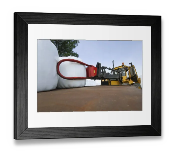 Framed Print : Plastic wrapped round silage bales, stacked onto trailer with mechanical loader, Sweden Framed Print : Plastic wrapped round silage bales, stacked onto trailer with mechanical loader, Sweden
