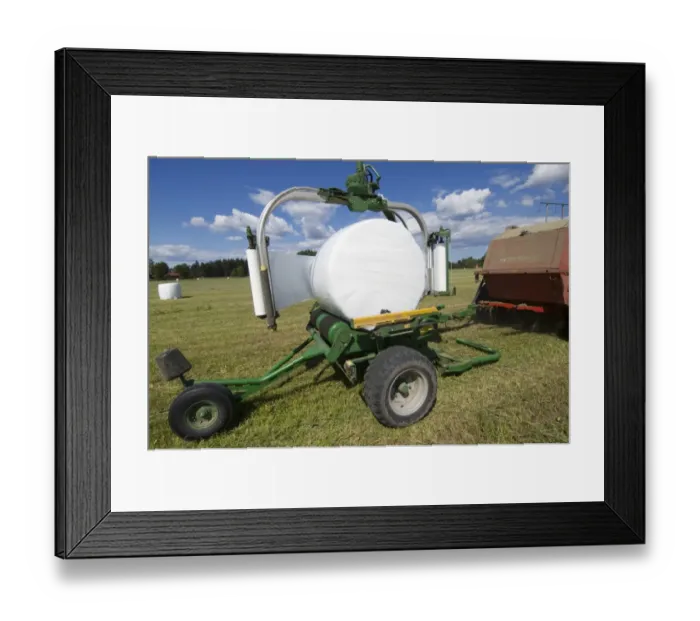 Framed Print : Plastic wrapped round silage bale, wrapped by mechanical bale-wrapper, Sweden Framed Print : Plastic wrapped round silage bale, wrapped by mechanical bale-wrapper, Sweden