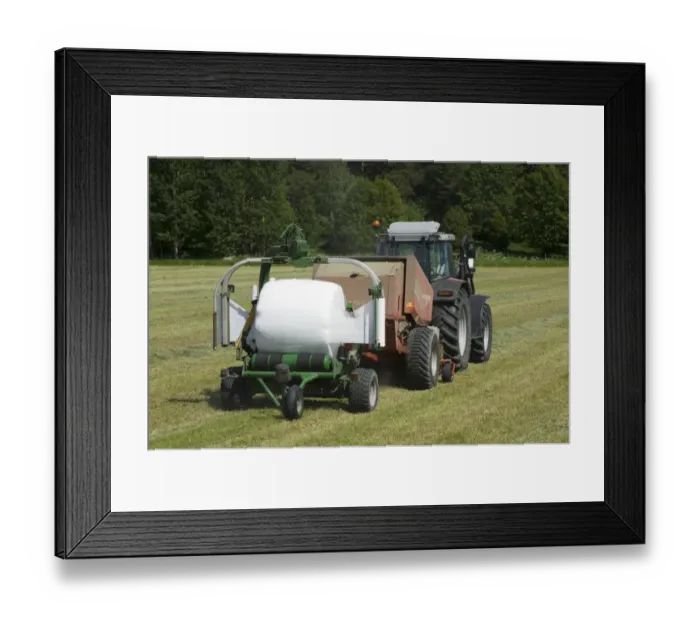 Framed Print : Tractor pulling baler and mechanical bale-wrapper, with plastic wrapped round silage bale, Sweden