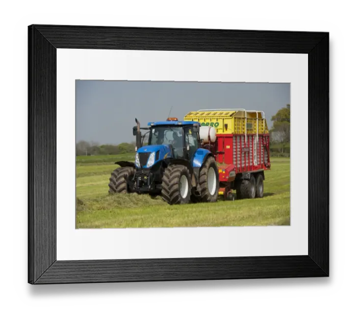 Framed Print : New Holland tractor with Pottinger forage wagon, picking up grass in silage field, Northumberland, England, May
