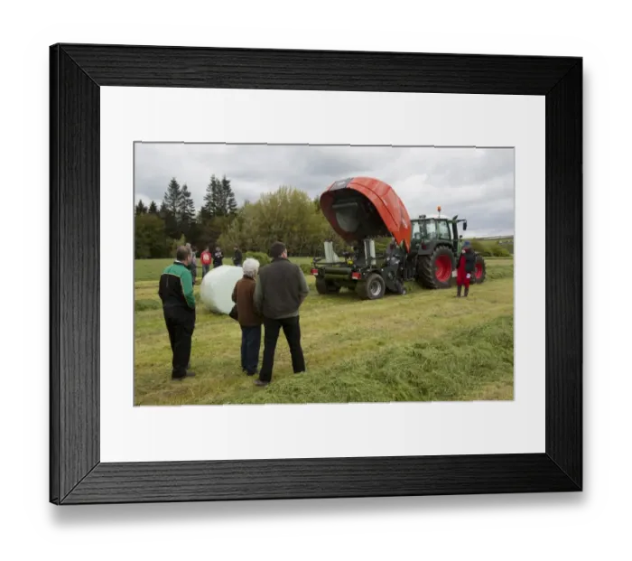 Framed Print : Kuhn all in one baler and wrapper, wrapping round silage bale in plastic at demonstration with farmers watching Framed Print : Kuhn all in one baler and wrapper, wrapping round silage bale in plastic at demonstration with farmers watching