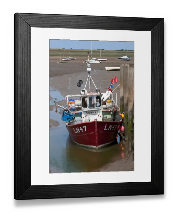 Framed Print : Fishing boat moored at jetty in coastal creek at low tide, Brancaster Harbour, Norfolk, England, July Framed Print : Fishing boat moored at jetty in coastal creek at low tide, Brancaster Harbour, Norfolk, England, July