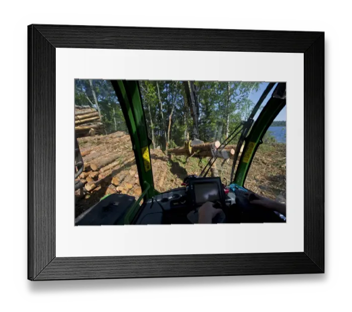 Framed Print : Interior of John Deere 1010E Forwarder loading logs onto timber barge, Archipelago Sea, Baltic Sea, Sweden, june Framed Print : Interior of John Deere 1010E Forwarder loading logs onto timber barge, Archipelago Sea, Baltic Sea, Sweden, june