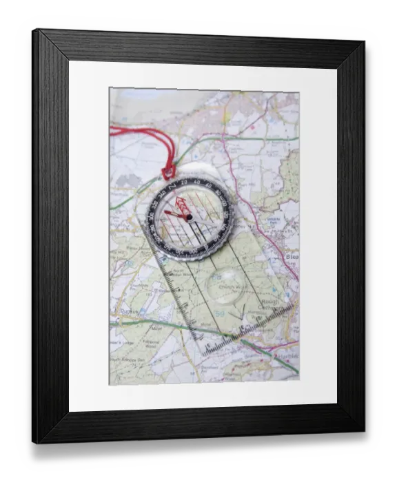 Framed Print : Compass on Ordnance Survey map of Kent, England, August Framed Print : Compass on Ordnance Survey map of Kent, England, August