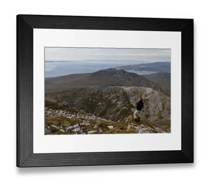Framed Print : Walker on mountain peak, view north across Loch Tarbert, northern part of Colonsay visible in northwest Framed Print : Walker on mountain peak, view north across Loch Tarbert, northern part of Colonsay visible in northwest