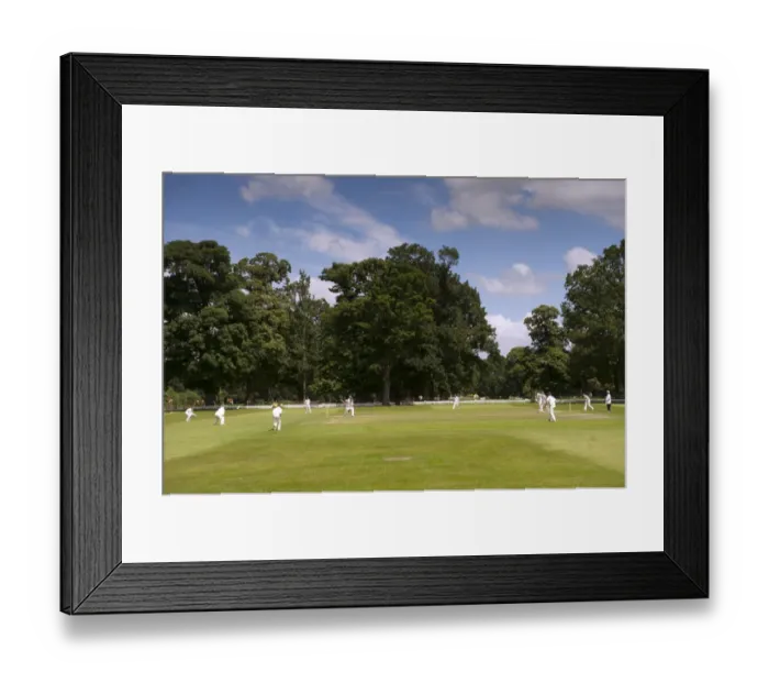 Framed Print : Cricket match being played on village pitch, on summer afternoon, England, July Framed Print : Cricket match being played on village pitch, on summer afternoon, England, July