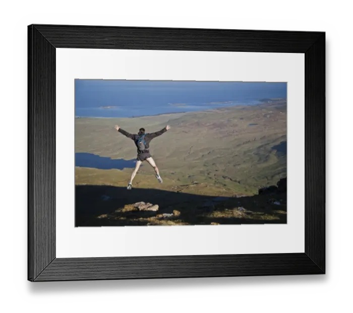 Framed Print : Fell runner jumping over rock (imitating base jump), coming down from mountain peak, with Loch an t-Siob in background Framed Print : Fell runner jumping over rock (imitating base jump), coming down from mountain peak, with Loch an t-Siob in background