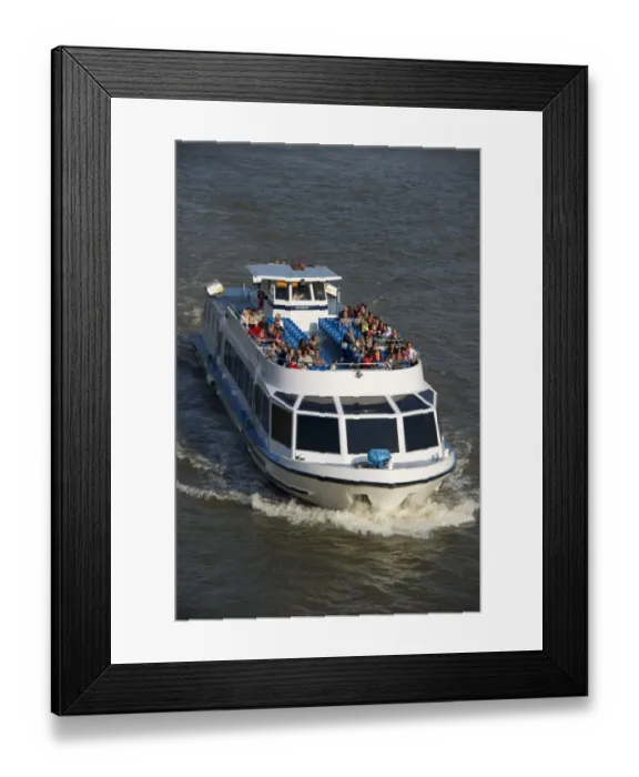 Framed Print : Tourist sightseeing boat on city river, River Thames, London, England, april Framed Print : Tourist sightseeing boat on city river, River Thames, London, England, april