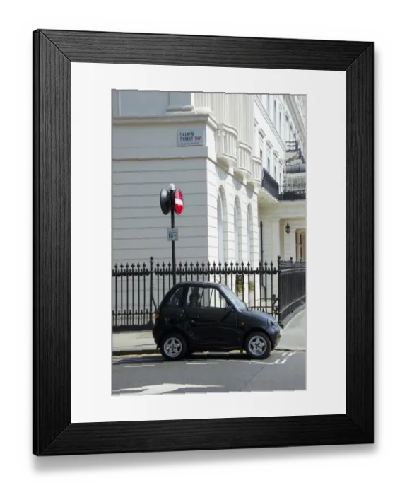 Framed Print : G-Wiz electric car parked on city street, Halkin Street, City of Westminster, London, England, april