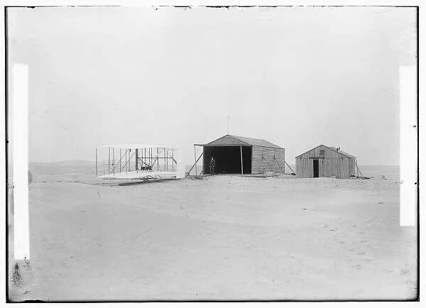 1903 machine and large camp building where it was housed, an