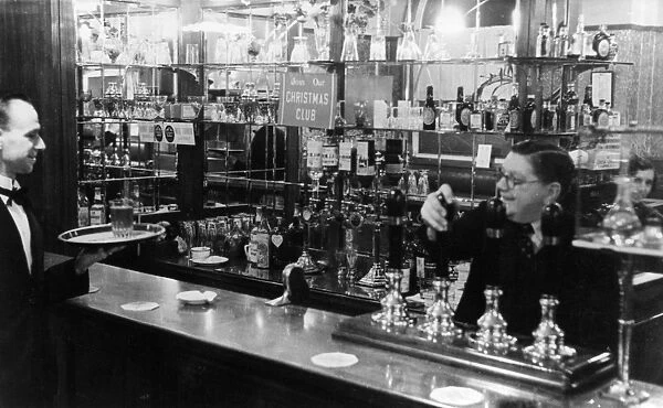 Barman and waiter working in a bar