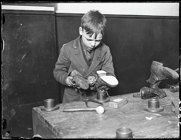 Boy Repairs Boots  /  1930