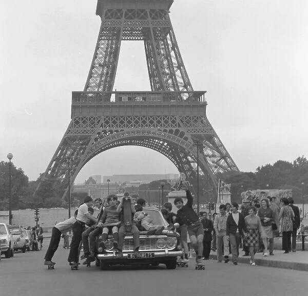 Boys riding on top of a car - Paris