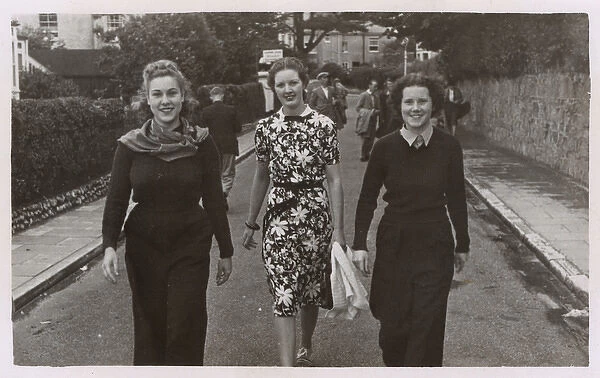 Candid Street snap - Three jolly young women walk down road