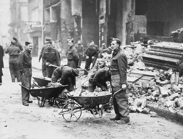 Clearing rubble from bombed buildings, London