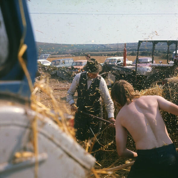 Two farmhands at harvest time