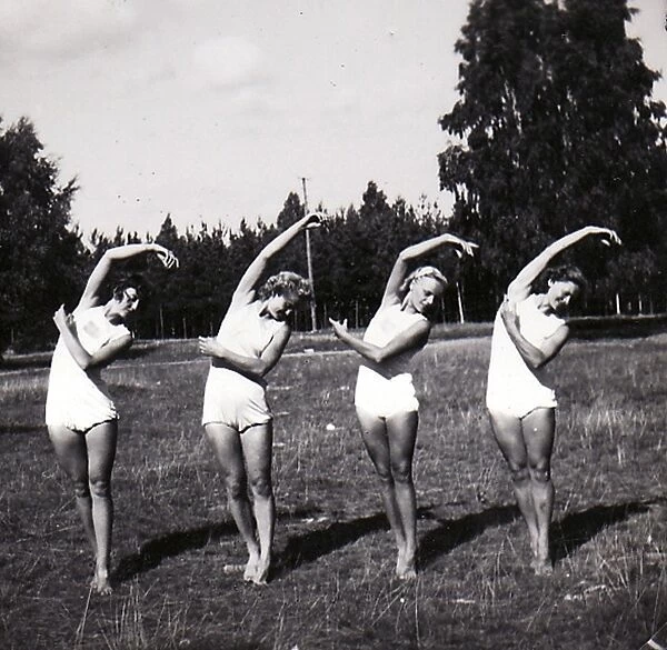 Four female gymnasts in row