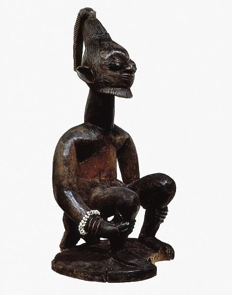 Figure on a log. Yoruba art