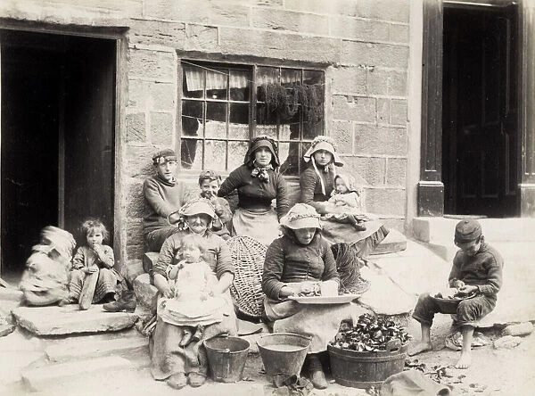 Fishing family outside their home in Staithes Yorkshire