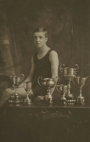 Fourteen year old swimming champion with trophies