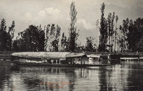 Houseboat (Dungar) on a river, Kashmir, India