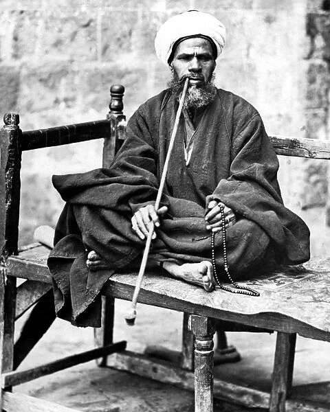 Man with pipe and beads, Egypt