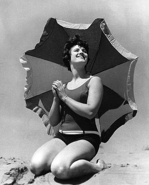 Woman on beach with sunshade