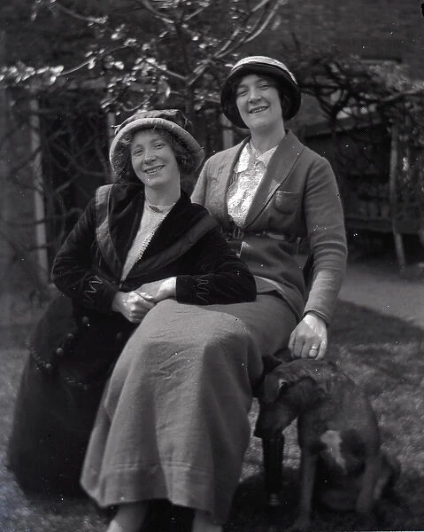 Two women posing in a garden
