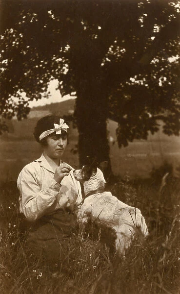 Young woman and dog in field