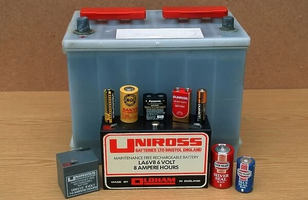 Display of different kinds of batteries including car lead acid dry and lithium cells of various sizes and rechargeables UK