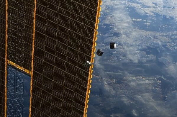 Satellites and ISS solar panel in space
