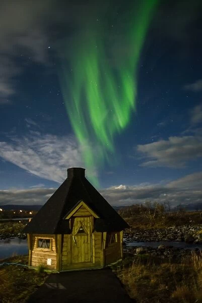 Aurora borealis over lakeside Kota (hut), Kilpisjarvi, Northwest Finland, Lapland