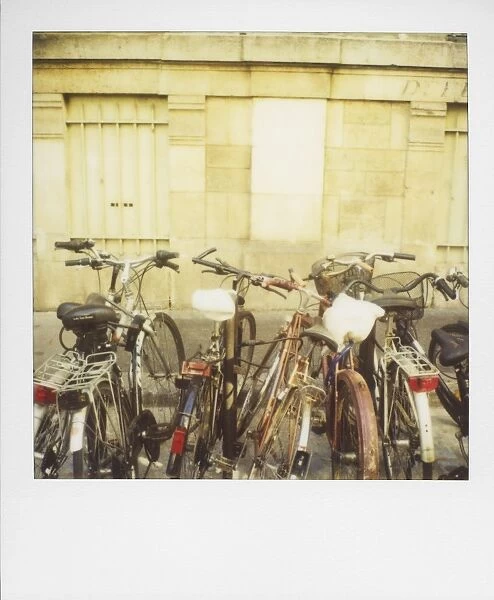 Bicycles stacked against stone wall, Paris, France, Europe